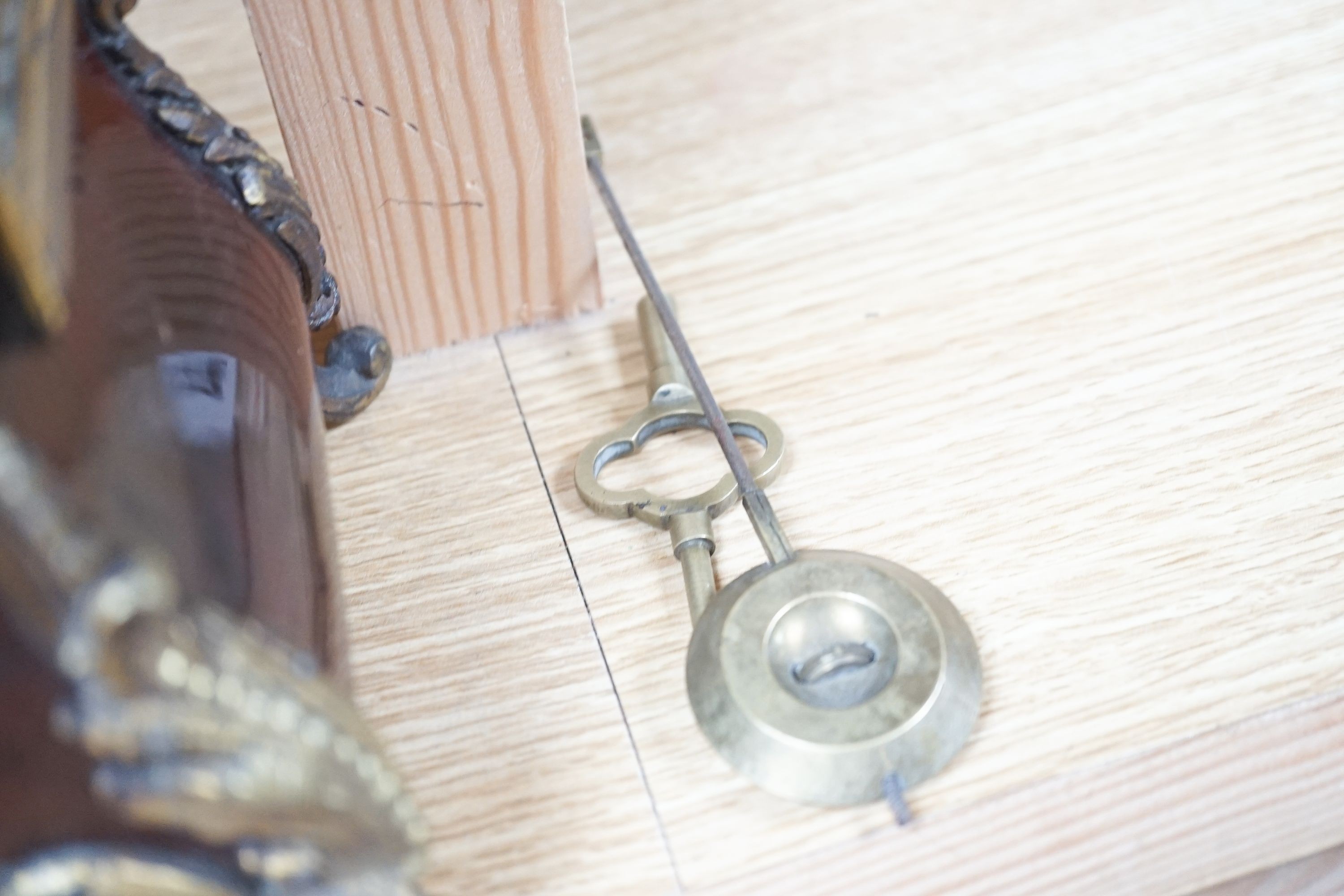 A 19th century French tortoiseshell and gilt metal mounted clock with key and pendulum 40cm